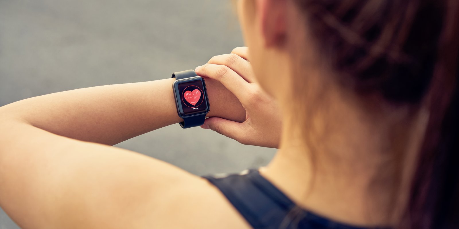 A lady with a smart watch checking her heart rate