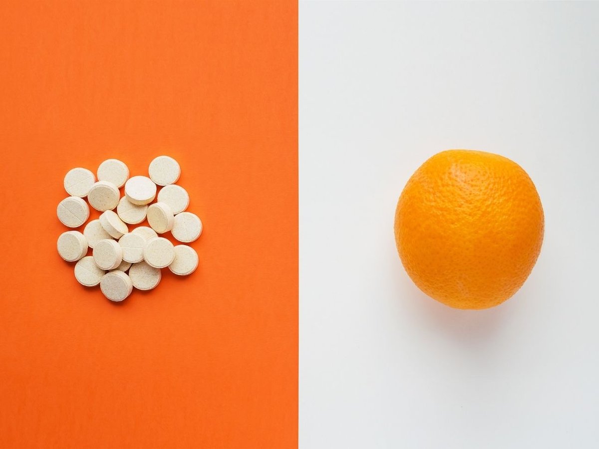 Some treatment medication and orange on a desk