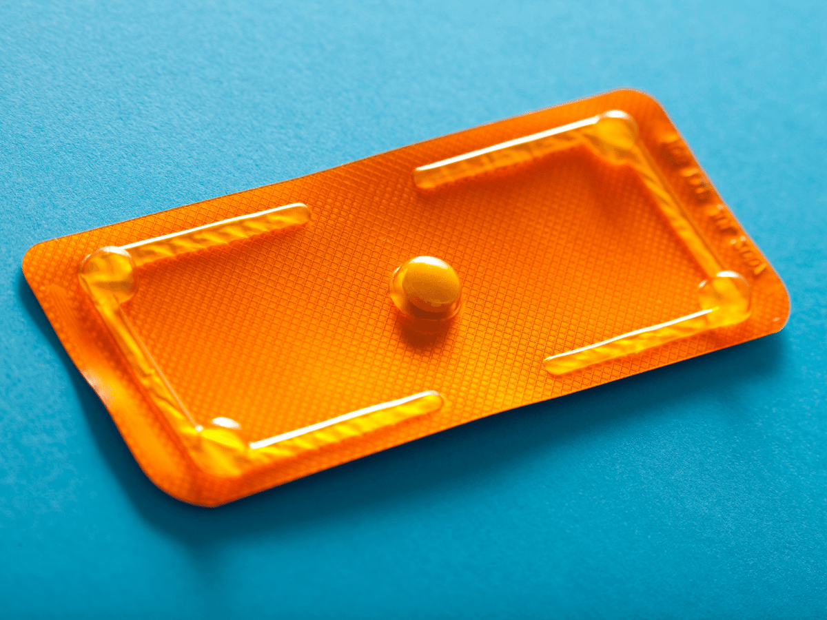 image of contraception pill on a blue table