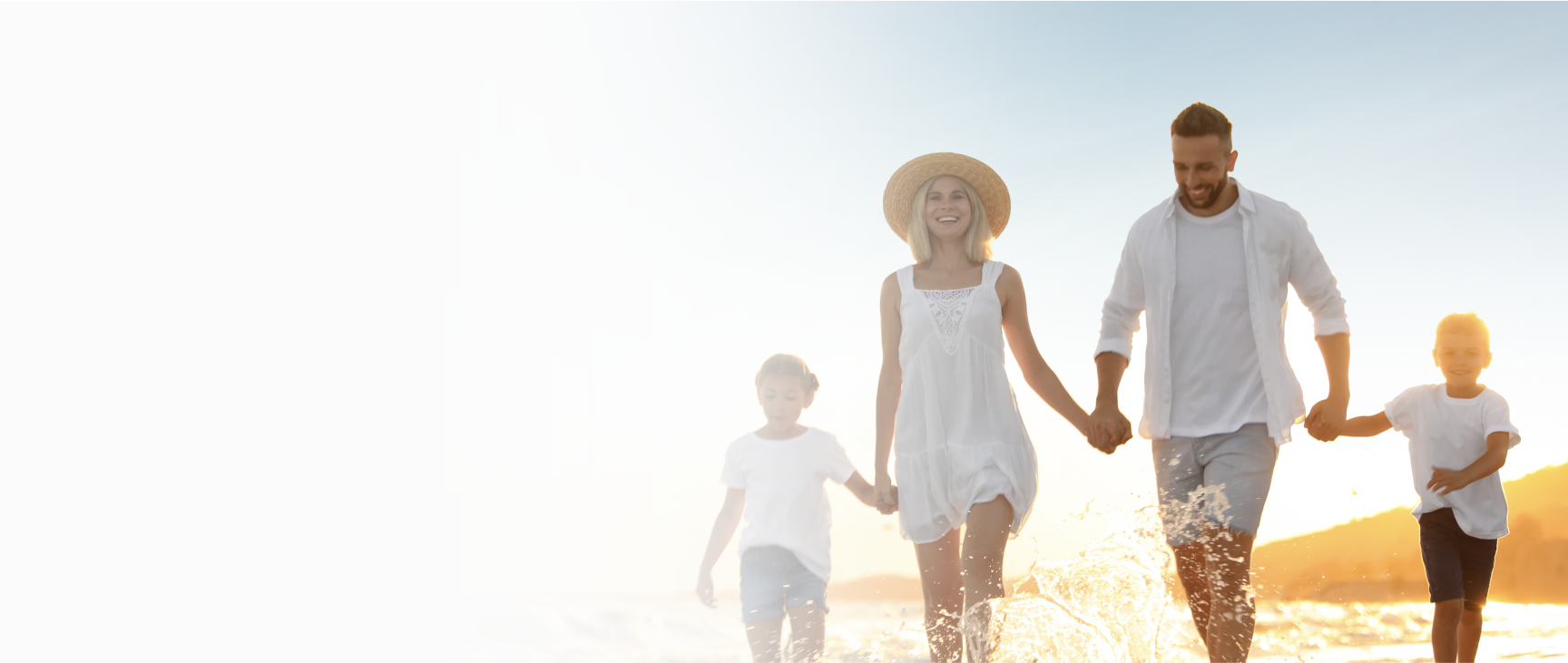 Smiling family holding hands at a beach